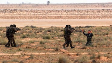 File photo of Tunisian soldiers act out an arrest during a presentation of the anti-extremist fence, in near Ben Guerdane, eastern Tunisia, close to the border with Libya. (AP)