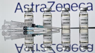 Vials with coronavirus stickers attached and syringes with the logo of British pharmaceutical company AstraZeneca on Nov. 17, 2020. (AFP)