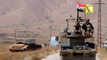 Hezbollah and Syrian flags flutter on a military vehicle in Western Qalamoun, Syria. (File Photo: Reuters)