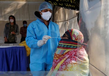 A healthcare worker collects a swab sample from a woman during a rapid antigen testing campaign for the coronavirus disease (COVID-19), in Ahmedabad, India, January 27, 2021. (File photo: Reuters)