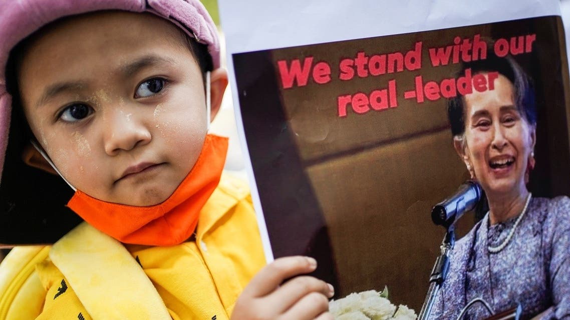 A child holds a picture of leader Aung San Suu Kyi outside the United Nations venue after the military seized power in a coup in Myanmar, in Bangkok, Thailand, on February 3, 2021. (Reuters)