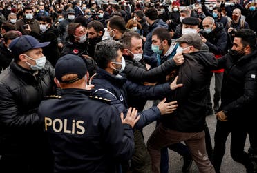 A plainclothes police officer grabs Ahmet Sik, independent member of Turkish Parliament, during a protest in Istanbul, on Feb. 2, 2021. (Reuters)