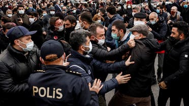A plainclothes police officer grabs Ahmet Sik, independent member of Turkish Parliament, by the jacket during a gathering in solidarity with Bogazici University students who are protesting against the appointment of Melih Bulu as new rector of the university, in Istanbul, Turkey, on February 2, 2021. (Reuters)