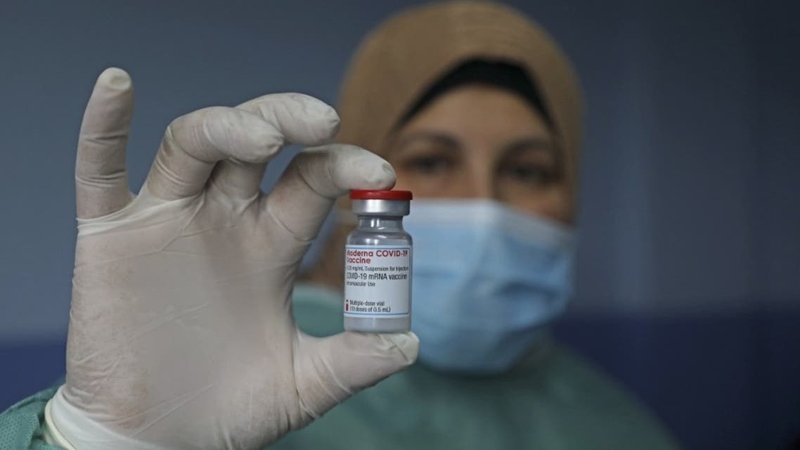 A Palestinian health worker holds a vial of Covid-19 vaccine at the Palestine Red Crescent hospital in the West Bank city of Nablus, on February 4, 2021. (AFP)