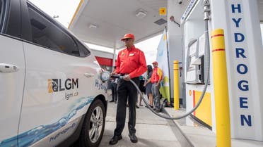 A Shell worker refuels a vehicle at the first retail hydrogen fuelling station in Vancouver, Canada. (Reuters)