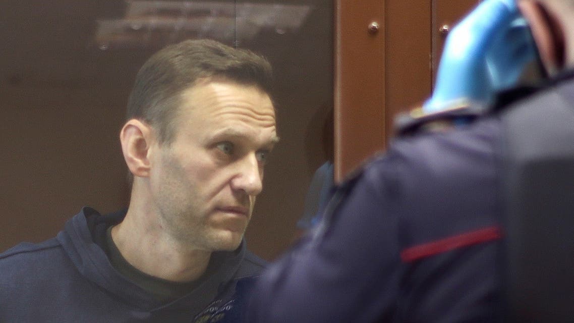 Kremlin critic Alexei Navalny, who is accused of slandering a Russian World War Two veteran, stands inside a defendant dock before a court hearing in Moscow, Russia, on February 5, 2021. (Reuters)