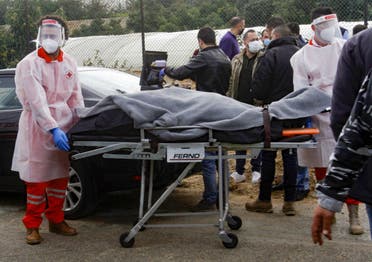 Medics evacuate the body of prominent Lebanese activist and intellectual Lokman Slim from the spot where he was found dead in his car near southern Lebanese city of Saida, on February 4, 2021. (AFP)