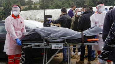 Medics evacuate the body of prominent Lebanese activist and intellectual Lokman Slim from the spot where he was found dead in his car near southern Lebanese city of Saida, on February 4, 2021. (AFP)
