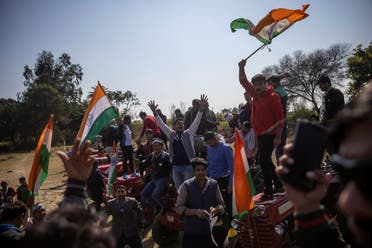 People shout slogans during a Maha Panchayat or grand village council meeting as part of a farmers’ protest against farm laws at Bhainswal in Shamli district in the northern state of Uttar Pradesh, India, on February 5, 2021. (Reuters)