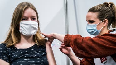 A medic receives a dose of a COVID-19 vaccine at the MartiniPlaza in Groningen, Netherlands, on January 15, 2021. (Siese Veenstra/ANP/AFP)