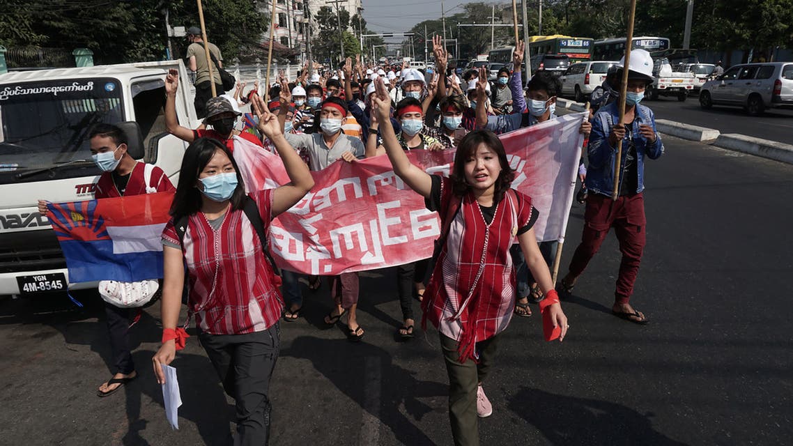 Protesters hold up the three finger salute during a demonstration against the military coup in Yangon on February 6, 2021. STR / AFP