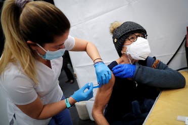 A healthcare worker administers a shot of the Moderna COVID-19 Vaccine to a woman at a pop-up vaccination site in Manhattan in New York City, New York, US, January 29, 2021. (Reuters)