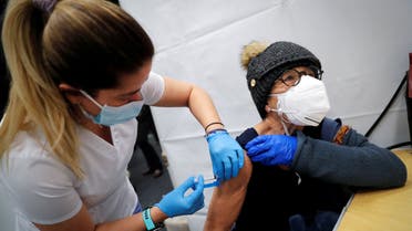 A healthcare worker administers a shot of the Moderna COVID-19 Vaccine to a woman at a pop-up vaccination site in Manhattan in New York City, New York, US, January 29, 2021. (Reuters)