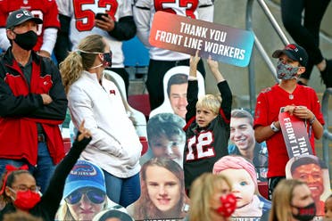 A fan holds a sign thanking front line workers before Super Bowl LV between the Kansas City Chiefs and the Tampa Bay Buccaneers. (Reuters)
