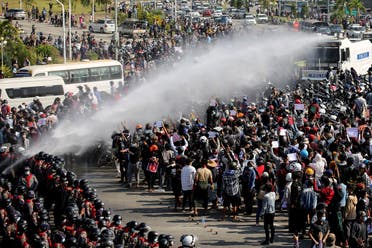 Police fire a water cannon at protesters demonstrating against the coup and demanding the release of elected leader Aung San Suu Kyi, in Naypyitaw, Myanmar, on February 8, 2021. (Reuters)