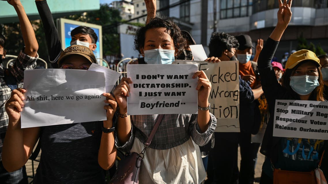 Protesters hold signs denouncing the military during a demonstration against the coup in Yangon on February 8, 2021. Ye Aung THU / AFP