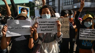Protesters hold signs denouncing the military during a demonstration against the coup in Yangon on February 8, 2021.  Ye Aung THU / AFP