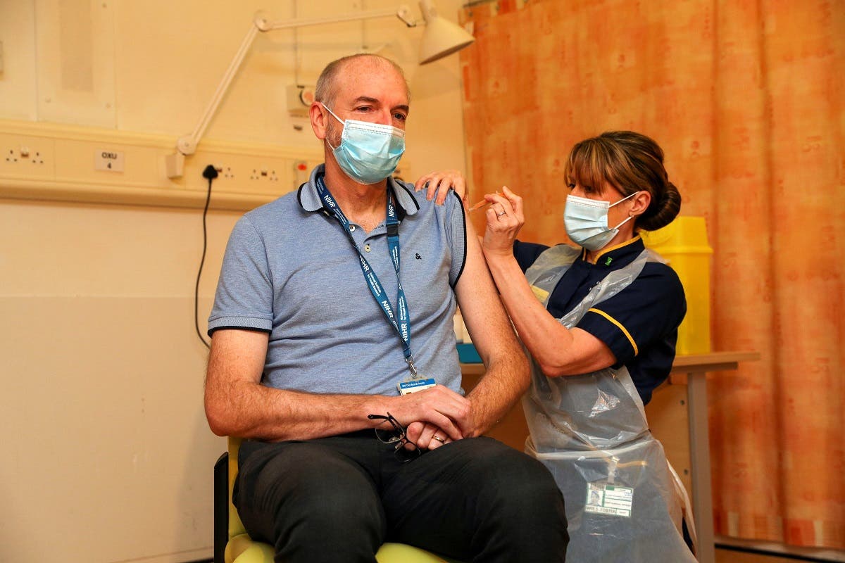 Professor Andrew Pollard, Director of the Oxford Vaccine Group (OVG), and a professor of Paediatric Infection and Immunity receives the Oxford University/AstraZeneca COVID-19 vaccine from nurse Sam Foster at the Churchill Hospital in Oxford, Britain, on January 4, 2021. (File photo: Reuters)