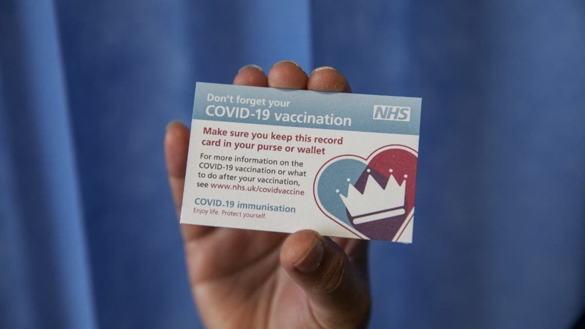 Senior nurse Dilhani Somaweera holds up a vaccination card for the Pfizer-BioNTech COVID-19 vaccine at the Royal Free hospital in London on December 8, 2020 at the start of the UK's biggest ever vaccination programme. (File photo: AFP)