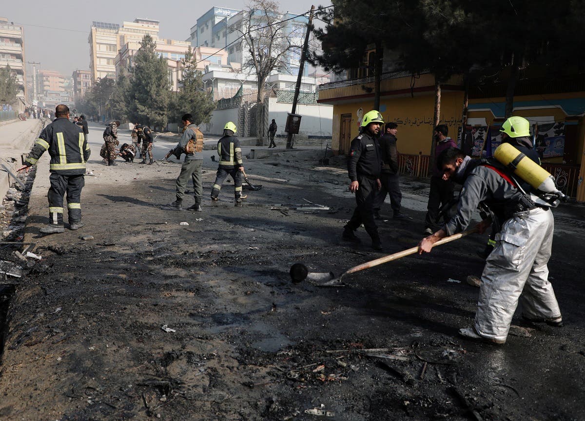 Afghan firefighters remove the remains of a burnt car at the site of a bomb blast in Kabul, Afghanistan January 10, 2021. (Reuters/Omar Sobhan)