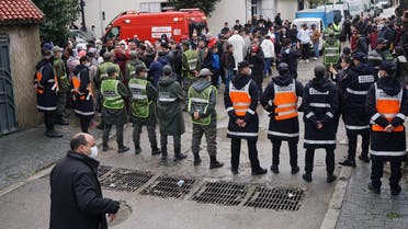 Emergency services gather at the site of illegal underground textile workshop that flooded after heavy rain fall in Morocco's city of Tangiers on February 8, 2021. (AFP)