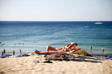 Tourists sunbathe at the beach in the resort town of Ayia Napa in southeastern Cyprus. (File photo: AFP)