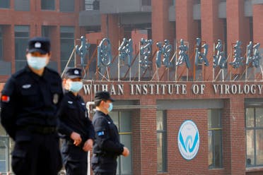 Security personnel keep watch outside Wuhan Institute of Virology during the visit by the World Health Organization (WHO) team tasked with investigating the origins of the coronavirus disease (COVID-19), in Wuhan, Hubei province, China, February 3, 2021. (Reuters)