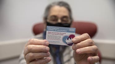 Bernice Wainer, 82, holds up her vaccination card as she receives a dose of the Pfizer-BioNTech Covid-19 vaccine at the Royal Free hospital in London on December 8, 2020 at the start of the UK's biggest ever vaccination programme. (File photo: AFP)