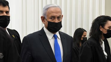 Israeli PM Netanyahu stands inside the courtroom just before the start of a hearing in his corruption trial at Jerusalem’s District Court February 8, 2021. (Reuben Castro/Pool via Reuters)