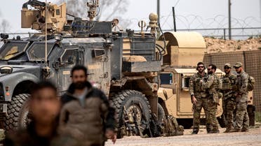 US soldiers gather around their military vehicles near Omar oil field in the eastern Syrian Deir Ezzor province on March 23, 2019, after US-backed Syrian Democratic Forces (SDF) announced the total elimination of the Islamic State (IS) group's last bastion in eastern Syria. Kurdish-led forces pronounced the death of the Islamic State group's nearly five-year-old caliphate early on March 23 after flushing out diehard jihadists from their very last bastion in eastern Syria. In Al-Omar, an oil field used as the main SDF staging base for the final phase of the assault, fighters in their best fatigues laid down their weapons and broke into song and dance.