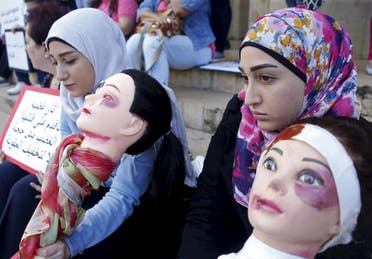 Activists carry mannequins with drawn-on bruises as they call for justice for the women killed by domestic violence in Lebanon, in Beirut May 30, 2015. (Reuters/Mohamed Azakir)