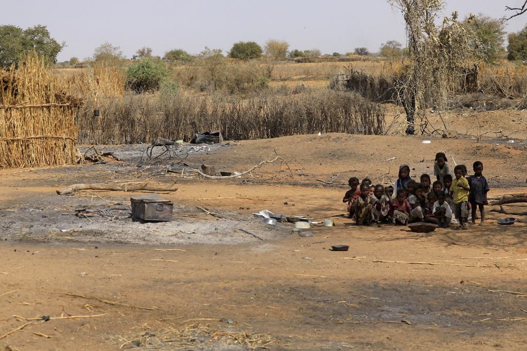 Sudanese children sit together following violence in the village of al-Twail Saadoun, 85 kilometres south of Nyala town, the capital of South Darfur, on February 2, 2021. (AFP)