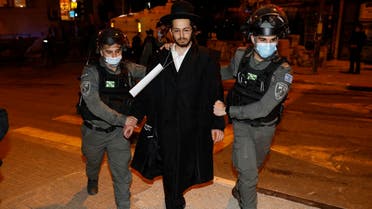 Israeli security forces arrest an ultra-Orthodox Jewish man during a protest in Jerusalem’s religious neighborhood of Mea Shearim, February 9, 2021. (Ahmad Gharabli /AFP)