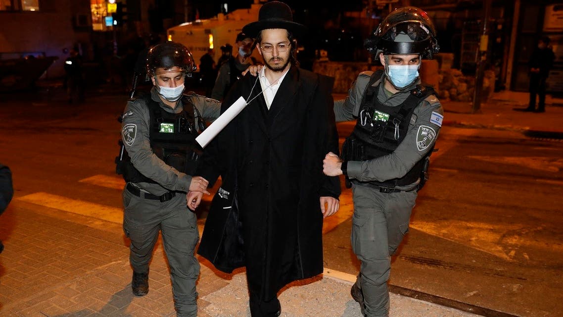 Israeli security forces arrest an ultra-Orthodox Jewish man during a protest in Jerusalem’s religious neighborhood of Mea Shearim, February 9, 2021. (Ahmad Gharabli /AFP)