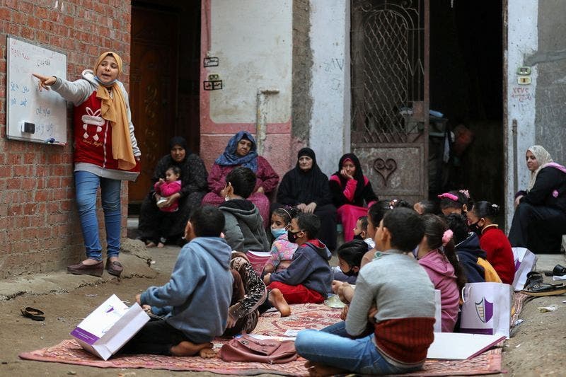Every day up to 30 children gather for school lessons in a narrow village street in Egypt’s northern Dakahlia province.(Reuters) 