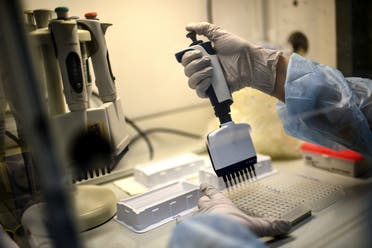 A laboratory technician wearing protective equipment works on the genome sequencing of the SARS-CoV-2 virus (Covid-19) and its variants at the Centre National de Reference (CNR - National Reference Centre) of respiratory infections viruses of the Pasteur Institute in Paris. (AFP)