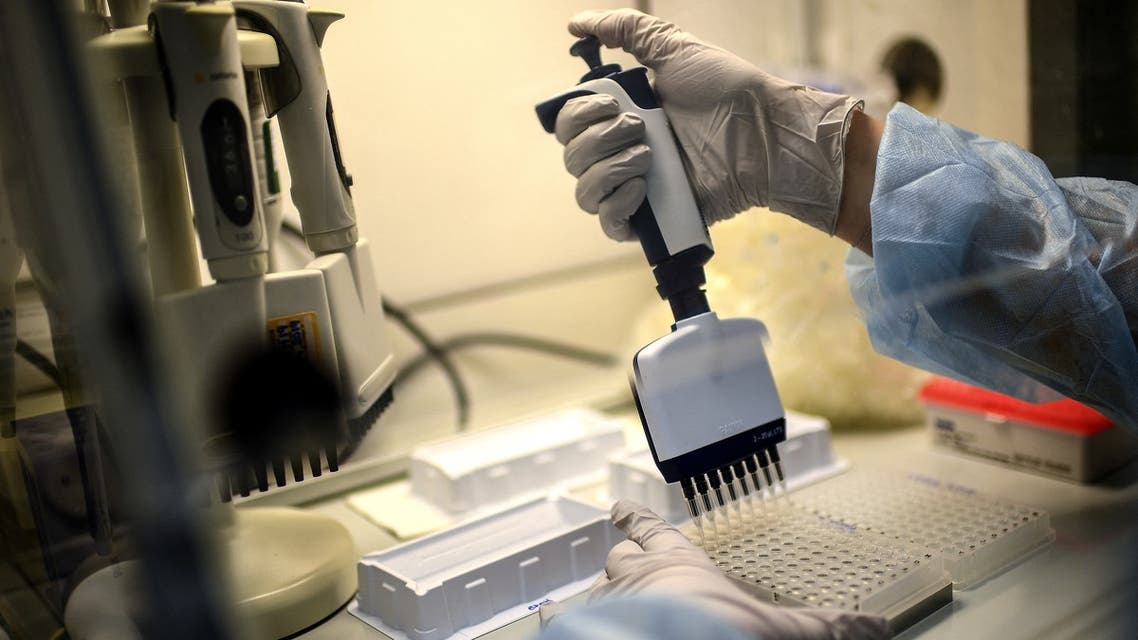  laboratory technician wearing protective equipment works on the genome sequencing of the SARS-CoV-2 virus (Covid-19) and its variants at the Centre National de Reference (CNR - National Reference Centre) of respiratory infections viruses of the Pasteur Institute in Paris. (AFP)