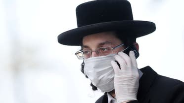 An Orthodox Jewish man wearing a protective face mask and gloves is seen in Stamford Hill, as the spread of the coronavirus disease (COVID-19) continues, London, Britain, April 8, 2020.  (Reuters)