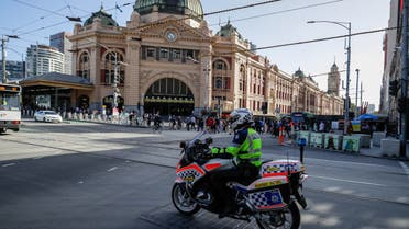 A policeman patrols on a motorcycle in Melbourne on February 12, 2021, after authorities ordered a five-day state-wide lockdown starting at midnight local time to stamp out a new coronavirus outbreak. (AFP)