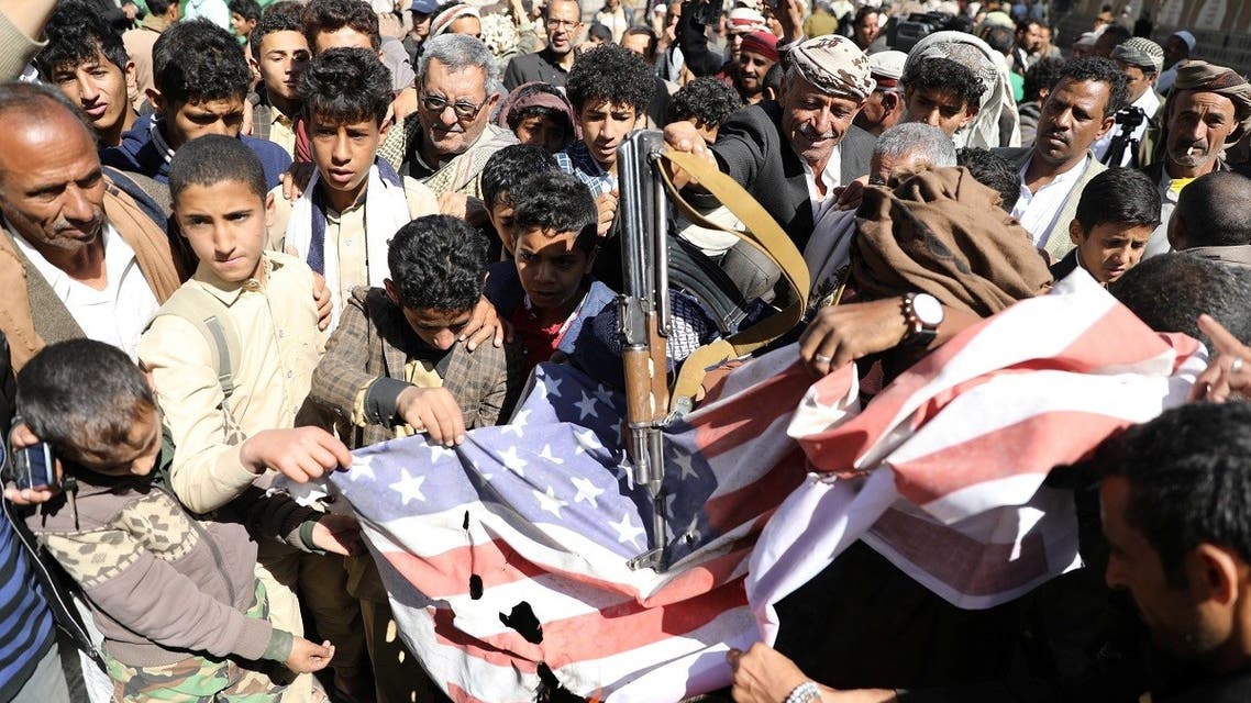 Houthi supporters shatter the US flag outside the US embassy in Sanaa, Jan. 18, 2021. (Reuters)