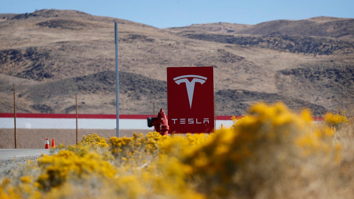 FILE - In this Oct. 13, 2018 file photo, a sign marks the entrance to the Tesla Gigafactory in Sparks, Nev. Tesla CEO Elon Musk solved a mystery involving a 27-year-old Russian who prosecutors say flew to the United States to offer a major-company insider $1 million to assist in a ransomware extortion attack on the firm. According to the billionaire, the scheme took aim at the electric car company’s 1.9 million-square-foot factory in Sparks, Nevada, which makes batteries for Tesla vehicles and energy storage units. (AP Photo/John Locher, File)