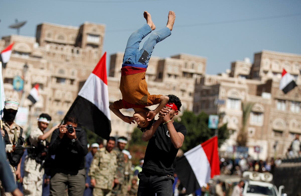 A boy displays skills during a parade held by newly recruited Houthi fighters before the fighters head to the frontline to fight against government forces, in Sanaa. (Reuters)