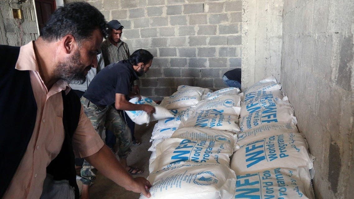 A file photo shows aid packages from the United Nations and the Syrian Arab Red Crescent (SARC) being delivered to locals in eastern Ghouta. (Amer Almohibany/AFP)