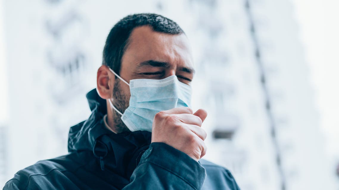 Portrait of young man on the street wearing face protective mask. (VioletaStoimenova via iStock)