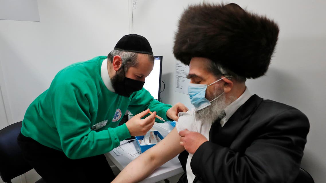  Rabbi Bieberfeld is administered a dose of the AstraZeneca coronavirus vaccine at an event to encourage vaccine uptake in Britain's Haredi Orthodox Jewish community at the John Scott Vaccination Centre in London, Saturday, February 13, 2021. (AP)