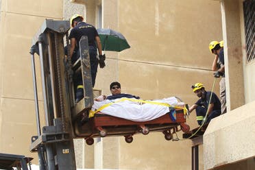 Saudi Civil Defence members use a forklift to move Khaled Mohsen Shaeri, 20, from his house in the Saudi city of Jizan, and to be airlifted to the capital Riyadh for medical treatment, August 19, 2013. (Reuters)