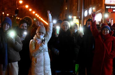People turn on the flashlights of their mobile phones during Valentine Day's flashmobs in support of jailed opposition politician Alexei Navalny in Saint Petersburg on February 14, 2021. (AFP)