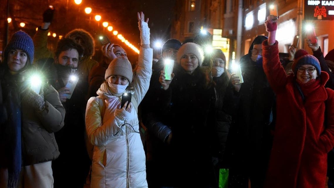 People turn on the flashlights of their mobile phones during Valentine Day's flashmobs in support of jailed opposition politician Alexei Navalny in Saint Petersburg on February 14, 2021. (AFP)