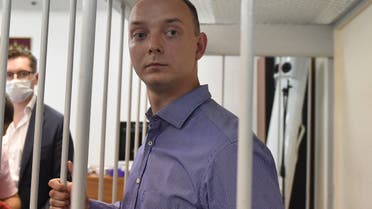 Ivan Safronov, a former journalist and aide to the head of Russia's space agency Roscosmos, detained on charges of treason for divulging state military secrets, stands inside a defendants' cage during a court hearing in Moscow on July 7, 2020. (AFP)