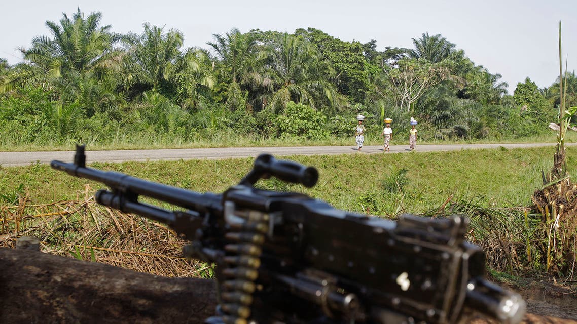 Women walk past a defensive position at a United Nations base on the outskirts of Walikale, Congo, in this September 17, 2010 file photo. (AP)